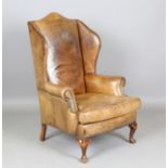 A mid-20th century George III style green leather wingback armchair, on cabriole legs, height 118cm,
