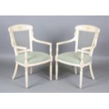 A pair of modern William McClean painted armchairs with woven string backs and overstuffed seats,
