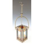 A late 19th century stained glass hanging lantern of rectangular form, the pierced brass trellis