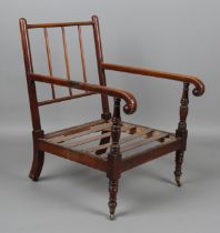 A George IV mahogany framed armchair, raised on ring turned legs and castors, height 95cm, width