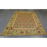 A Victorian style needlework carpet, 20th century, the yellow field with overall floral spray