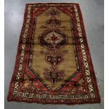 A Hamadan rug, North-west Persia, mid/late 20th century, the khaki field with a pole medallion,