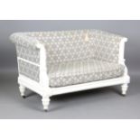 A modern Julian Chichester Regency style white painted showframe two-seat settee, the frame carved