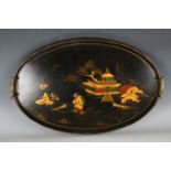 A George V black chinoiserie lacquered oval tray with galleried rim and shaped brass handles,