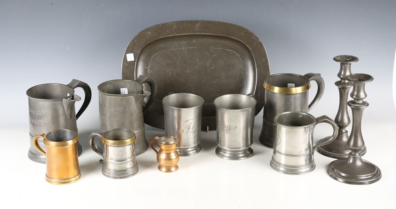 A group of 18th and 19th century pewter, including a platter, length 36cm, an 18th century tankard