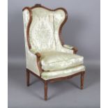 An early 20th century French Louis XVI style walnut showframe armchair, upholstered in patterned