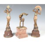 A modern Art Deco style patinated metal figure depicting a female gymnast, raised on a marble
