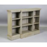 An early 20th century green painted breakfront open bookcase, height 97cm, width 133cm, depth 31cm.