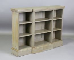 An early 20th century green painted breakfront open bookcase, height 97cm, width 133cm, depth 31cm.