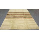 A contemporary design carpet, modern, the ivory field with a central band of polychrome stripes,