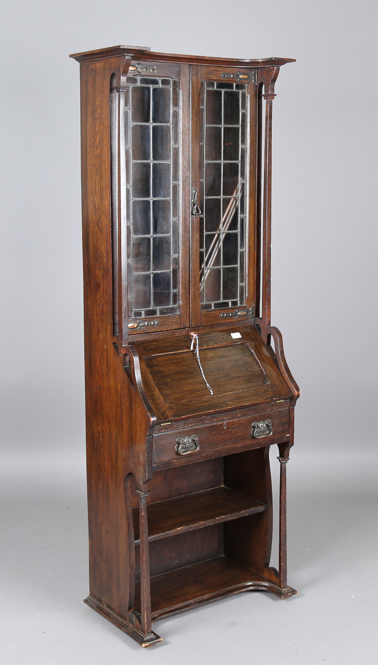 An early 20th century Arts and Crafts oak bureau bookcase, in the manner of Liberty & Co, height