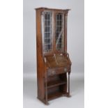An early 20th century Arts and Crafts oak bureau bookcase, in the manner of Liberty & Co, height