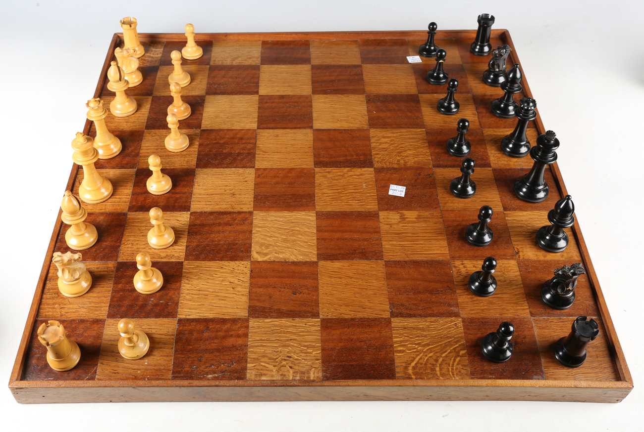 A late 19th/early 20th century boxwood and ebonized Staunton chess set, all with weighted bases,