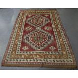 A Turkish Kazak style rug, mid-20th century, the pink field with two bold medallions, within a