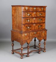 An early 18th century walnut chest-on-stand, the oak-lined drawers with later brass handles,
