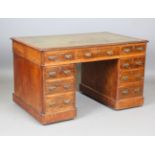 A late Victorian walnut twin pedestal desk, the top inset with gilt-tooled leather, height 71cm,