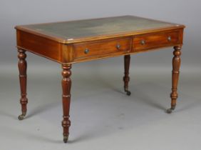 A 20th century Victorian style mahogany writing table, the top inset with gilt-tooled green