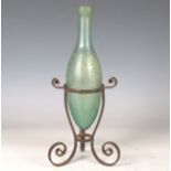 A late 19th century wrought iron Hamilton bottle stand of scroll form, height 18cm, together with