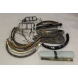 A collection of vintage bicycle parts, including mudguards, chain guards, rear hubs, tool kits,