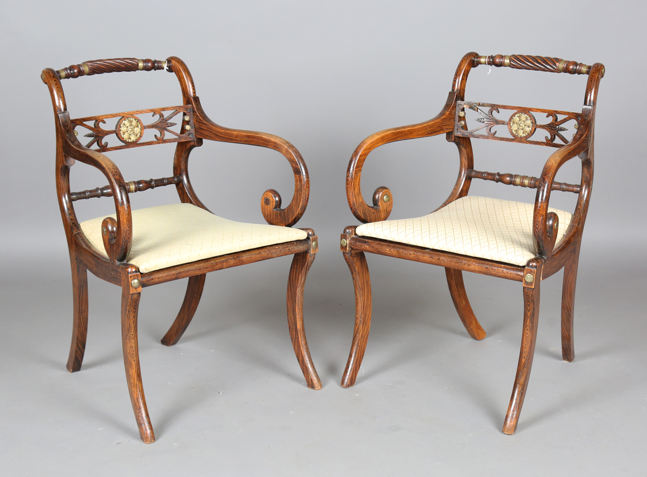 A set of eight Regency simulated rosewood and gilt brass mounted dining chairs, the centre rails