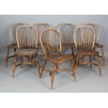 A set of seven late 20th century ash and elm Windsor kitchen chairs with shaped seats and
