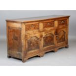A late 18th century provincial oak dresser base, fitted with three drawers above three arched