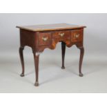 A George III provincial oak lowboy, the top and three drawers with inlaid borders, height 69cm,