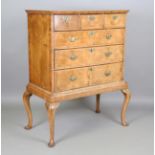 A George I walnut chest of oak-lined drawers, raised on a later stand, height 136cm, width 110cm,