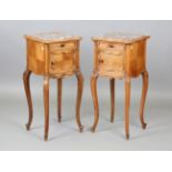 A pair of late 19th/early 20th century French walnut bedside cabinets with inset rouge marble tops