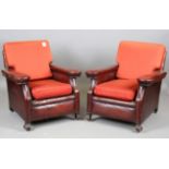 A pair of French Art Deco red leather club armchairs, raised on carved feet, height 82cm, width