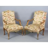 A pair of 20th century French beech framed fauteuil armchairs with carved and gilt decoration,