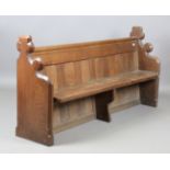 A late Victorian oak pew with shaped gothic sides, height 91cm, width 187cm, depth 46cm.Buyer’s