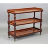 A late Victorian mahogany three-tier buffet, in the manner of James Shoolbred, raised on gilt