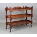 A mid-Victorian mahogany three-tier buffet with a carved gallery and brass spoked castors, height