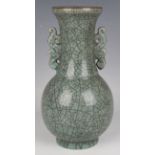 A Chinese Guan-type two-handled vase, the globular body and flared narrow neck covered in an olive