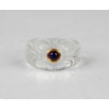 An Indian rock crystal ring, the front carved with a foliate design centred with a cabochon