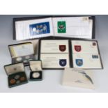 A collection of various British and world commemorative coins, including a First Coinage of the