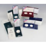 A large collection of USA United States Mint deluxe-cased silver proof dollar and half-dollar