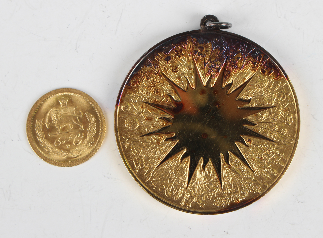 A Mohammed Reza Shah gold quarter-pahlavi, weight 2g, together with a John Pinches Ltd silver gilt - Image 2 of 2