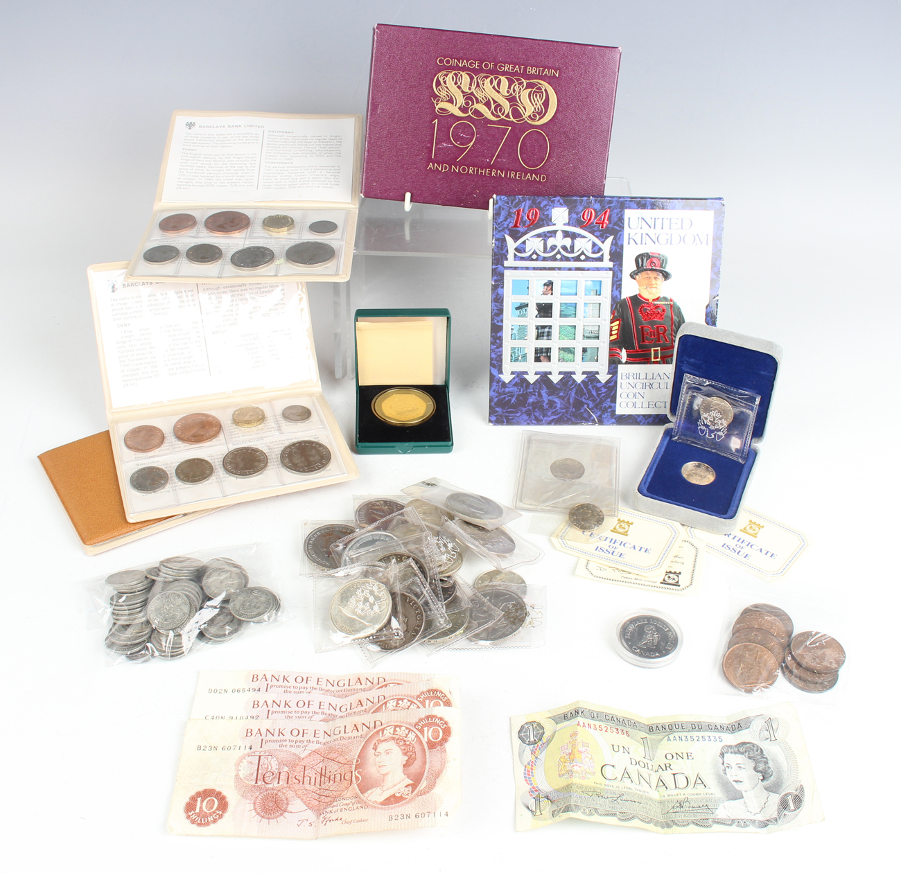 A group of British and world coins and banknotes, including proof coins sets, a group of pre-1947