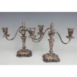 A pair of 20th century plated twin scroll branch candelabra, each with urn shaped sconces and square