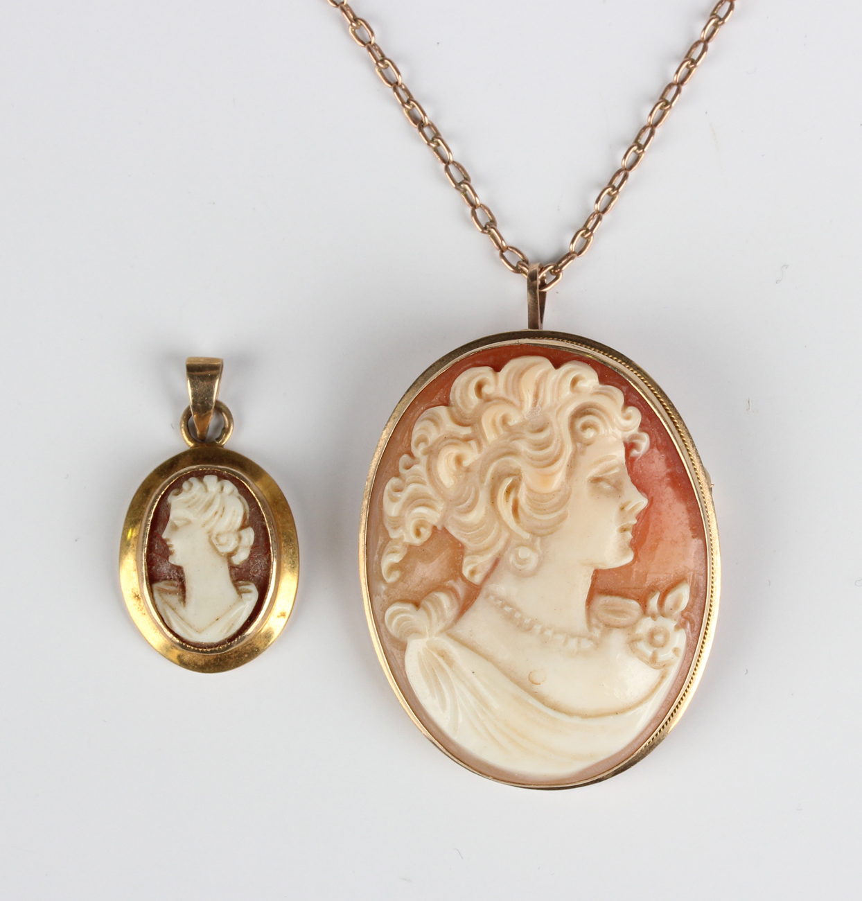 A gold mounted oval shell cameo pendant, carved as a portrait of a lady, detailed '9K Italy', length