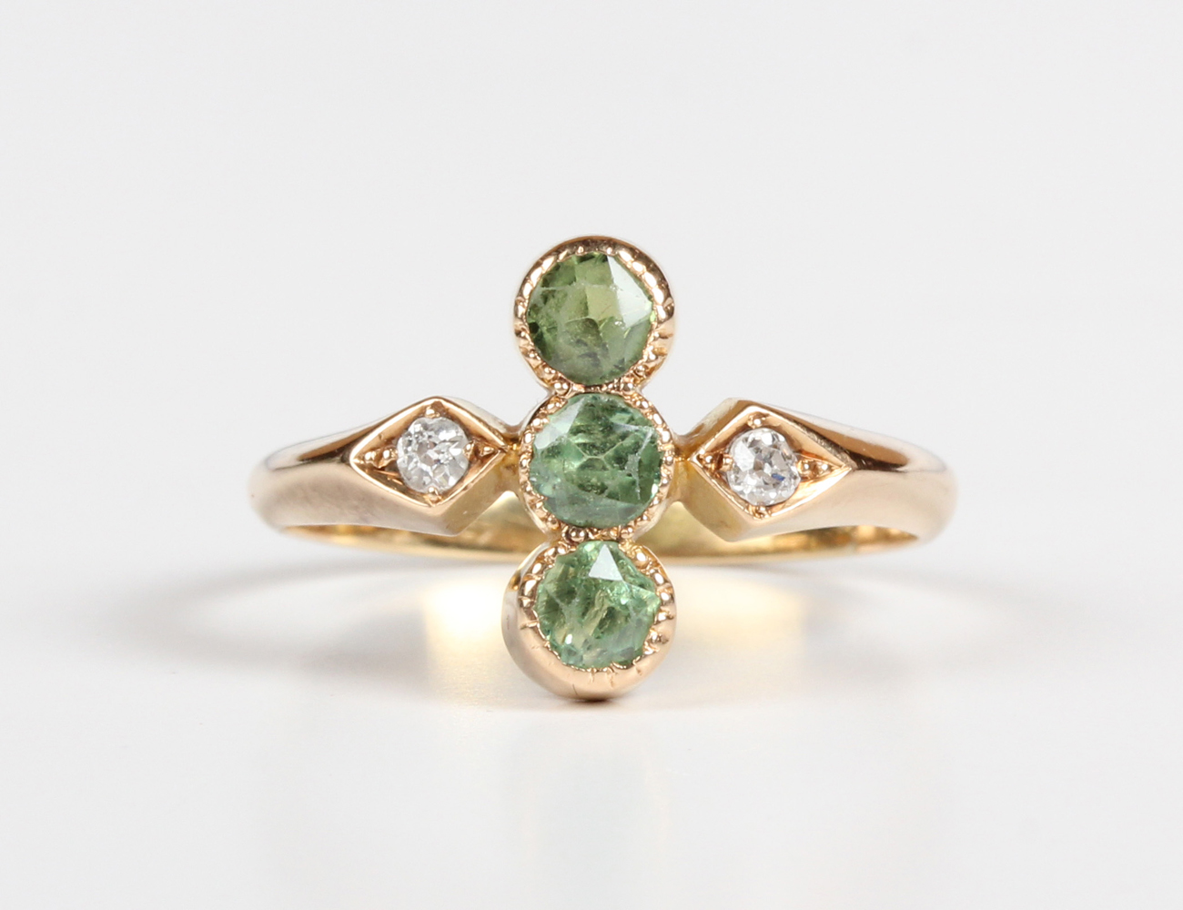 A gold, demantoid garnet and diamond ring, early 20th century, collet set with three circular cut - Image 5 of 5