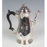 A George III silver coffee pot of baluster form, the domed hinged lid above an ebonized scroll