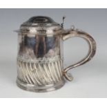 A William III silver tankard, the slightly tapered cylindrical body engraved with an armorial