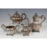 An early Victorian harlequin silver four-piece tea set, each piece of lobed melon form with scroll