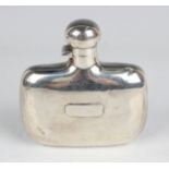 An Edwardian silver hip flask of curved oblong form with screw hinged lid, Sheffield 1909 by James