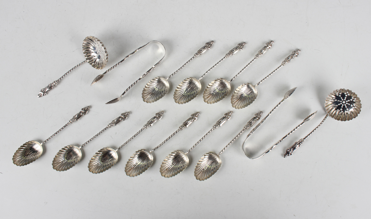 A set of six late Victorian silver apostle teaspoons, matching pair of sugar tongs and sifter spoon,