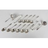 A set of six late Victorian silver apostle teaspoons, matching pair of sugar tongs and sifter spoon,