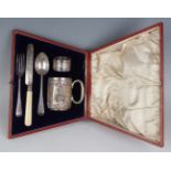 An Edwardian silver five-piece christening set, comprising cylindrical mug with loop handle,